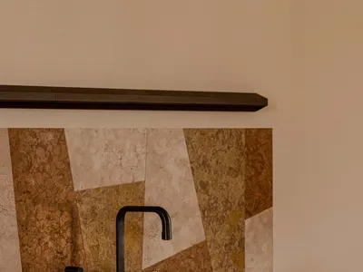 A minimalist kitchen with a marble countertop and sink.