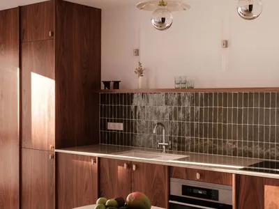 A modern kitchen with wooden cabinets, a marble countertop, and a backsplash of dark tiles.