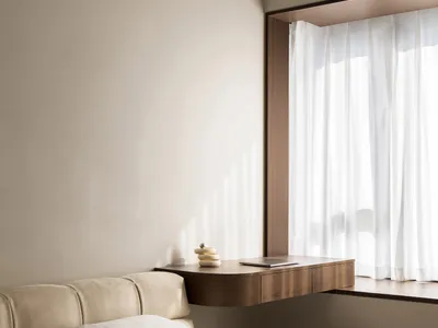 Minimalist bedroom featuring a bed with white linens and a wooden floating desk by the window.