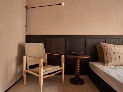 Modern minimalist bedroom with wooden furniture and fabric accents
