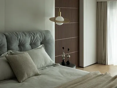 A minimalist bedroom featuring a modern design with a wooden texture wall panel, a gray upholstered bed, and a pendant light.