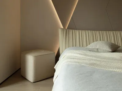 A modern minimalist bedroom featuring a leatherette upholstered bed and geometric lighting fixture