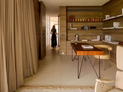 A modern home office featuring wooden walls and a minimalist design.