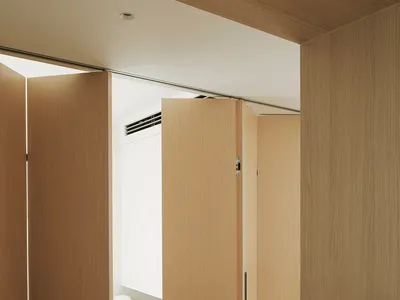 A minimalist bedroom with a wooden platform bed