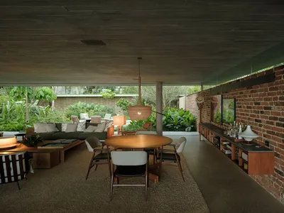 Industrial style living room with concrete ceiling, brick wall, and furniture.
