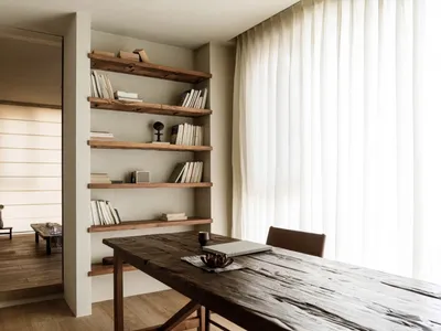 A rustic home office featuring industrial-style shelving made of reclaimed wood.