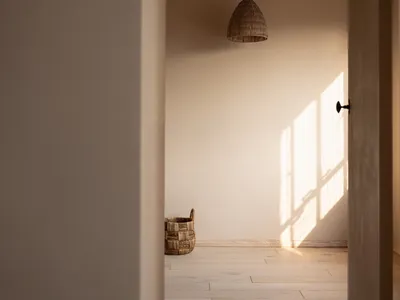 Minimalist bedroom featuring a wooden floor with natural light.