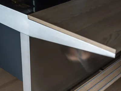 A modern kitchen with a marble countertop and steel accents.