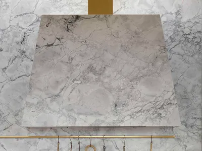 Modern kitchen featuring marble countertops and backsplash.