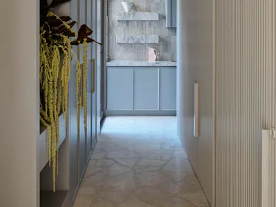Modern kitchen featuring marble surfaces and white cabinetry, with a minimalist design.