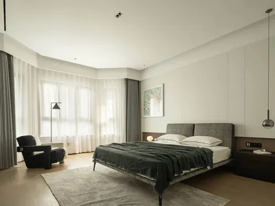 A modern, minimalist bedroom featuring wood, fabric, metal, and glass materials in a clean, open layout.