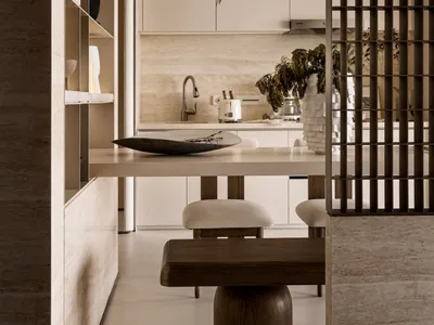 Minimalist kitchen with white cabinets and modern lighting fixture.