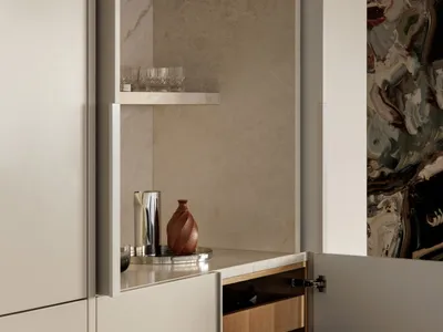 Modern kitchen interior featuring wood cabinetry and glassware.