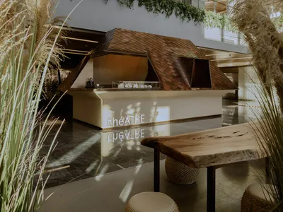 A modern bar with wooden elements and greenery