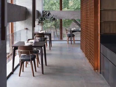 Modern restaurant with concrete walls and wooden tables and chairs