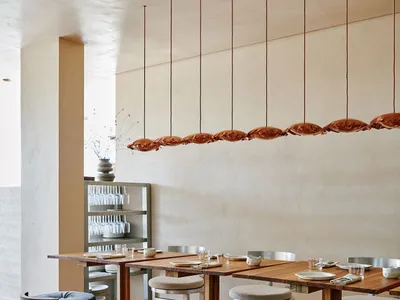 A modern restaurant interior with wooden furniture and a warm, welcoming atmosphere.