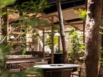 Indoor restaurant interior with industrial design elements such as wood and glass.