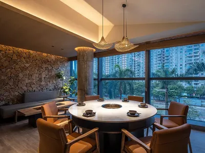 An industrial-style restaurant with marble accents and seating.