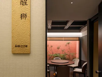 Contemporary restaurant interior with modern furniture, wooden tables, and minimalist decor.