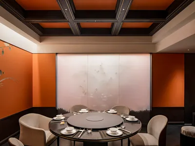 Modern restaurant private dining room with fabric chairs and wooden table.