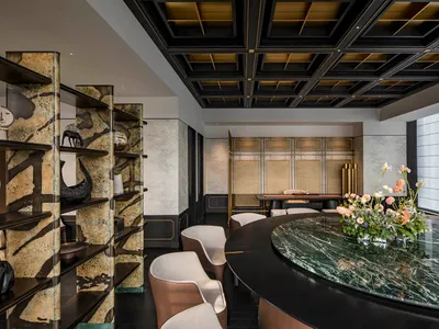 Modern restaurant bar with a combination of marble, concrete, and metallic materials.