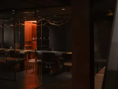 Modern restaurant interior with wooden tables, concrete flooring, and minimalist design.