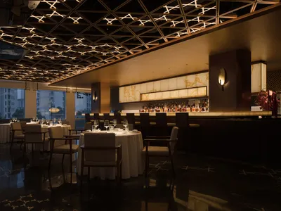 A sophisticated restaurant interior with a luxurious marble ceiling and elegant decor.