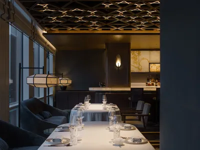 Modern restaurant interior with wooden walls, metal accents, and minimalist decor.