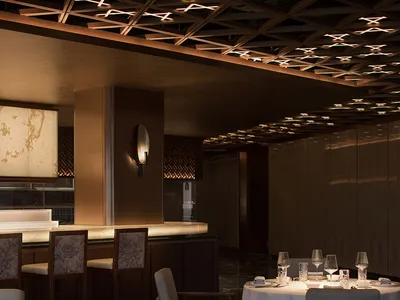Modern restaurant interior with metallic tile flooring and white marble walls and countertops.
