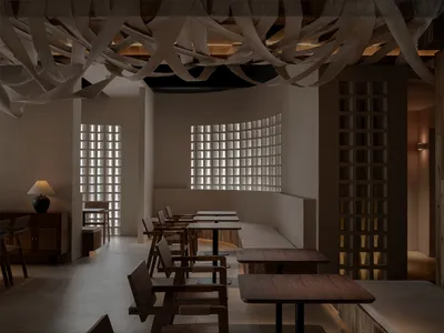 A cafe interior featuring wooden furniture and a grid-patterned window.