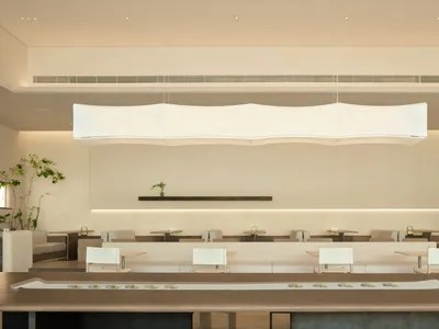 A minimalist modern restaurant interior designed with contemporary furniture and clean lines.
