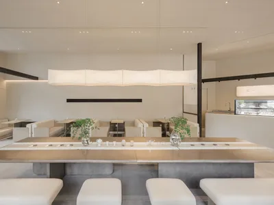 Minimalist restaurant interior with concrete tables and seating.