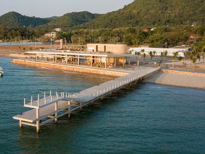 Modern, concrete beachside restaurant with large overwater terrace