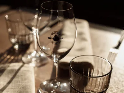 Empty wine glasses and a drink glass on a table.