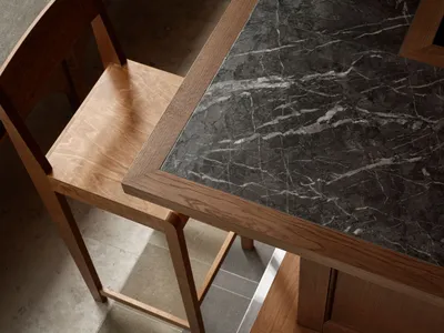 Marble countertop with wood frame in a commercial setting.