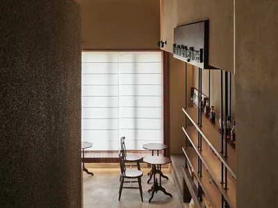 Modern cafe interior featuring wooden shelves and tables