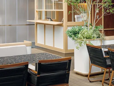 Outdoor seating and modern glass facade of a cafe