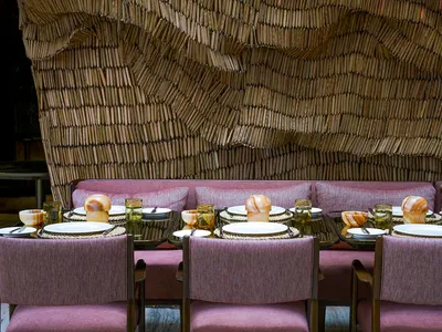 A cozy dining room with wooden furniture and a textured wall.
