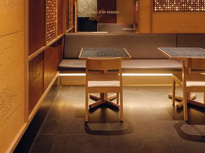 Modern restaurant interior with concrete walls and floors