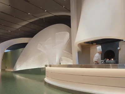 Modern restaurant interior with minimalist design and ceramic tile flooring.