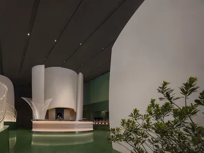 A modern hotel reception area with sleek, industrial-inspired design elements.