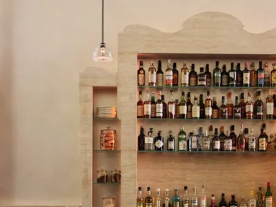 A stylish interior design featuring marble bar stools and a polished counter.