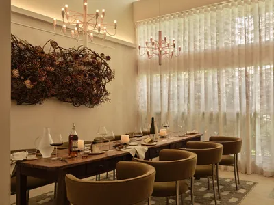 A modern dining room with decorative lighting and elegant furniture.
