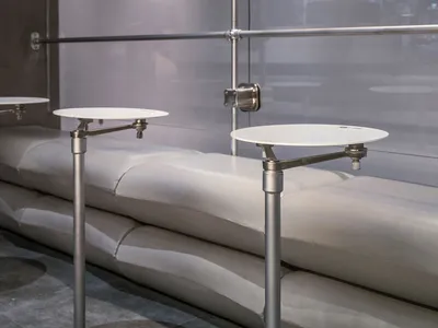 A sleek, modern restaurant bar featuring polished concrete surfaces and minimalist design elements.