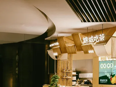 Modern restaurant interior designed with wooden elements and a minimalist aesthetic.