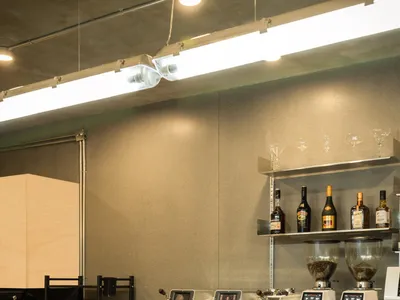 A coffee shop interior with a wood and metal bar counter.