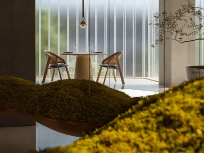 A modern restaurant interior featuring a minimalist design with concrete and glass elements.