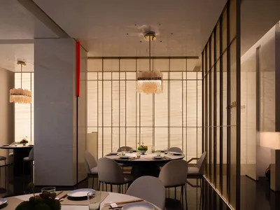 A modern minimalist restaurant interior with fabric curtains, metallic accents, and marble tables and chairs.