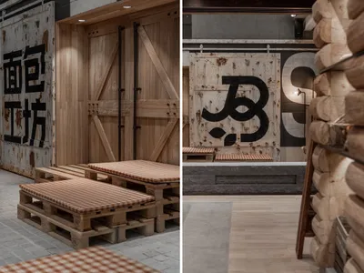 Industrial design restaurant interior with concrete walls, pallet seating, and steel paneling.