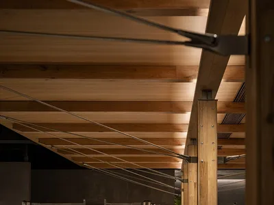 A photograph of an industrial restaurant interior featuring wooden elements.